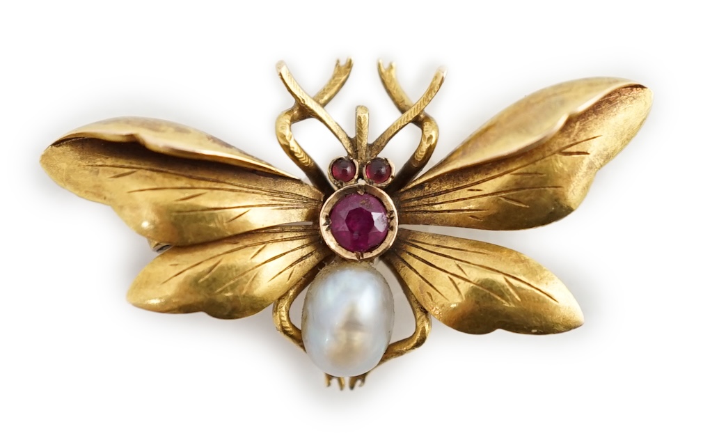 An early 20th century gold (stamped 18), ruby and baroque pearl set bug brooch